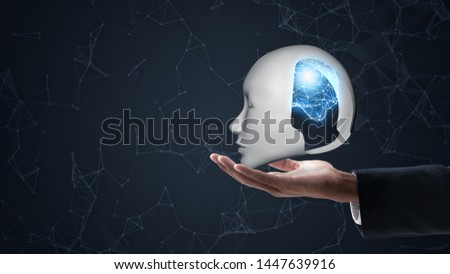 hand holding head robot with abstract brain structure.AI (Artificial Intelligence) concept.