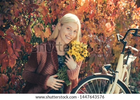 Girl with bicycle and flowers. Woman with bicycle autumn garden. Weekend activity. Active leisure and lifestyle. Girl ride bicycle for fun. Blonde enjoy relax park garden. Autumn bouquet. Warm autumn.