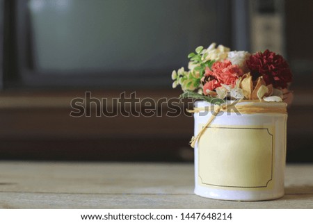 Close-up of a bouquet of flowers in small pots on old wooden floors selective focus and shallow depth of field