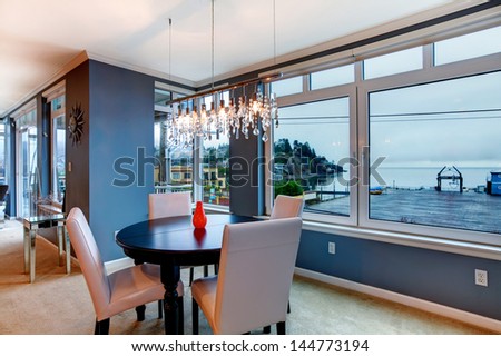 City apartment dining room with round small table and blue walls.