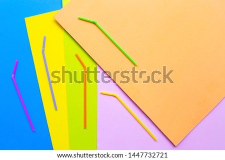 Colorful plastic  straws on colorful background. Plastic waste pollution.