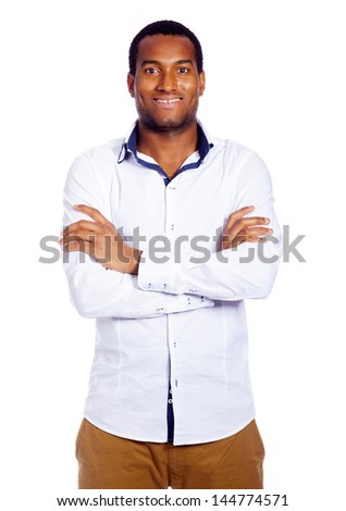 Casual young man looking at camera with arms crossed, isolated on white