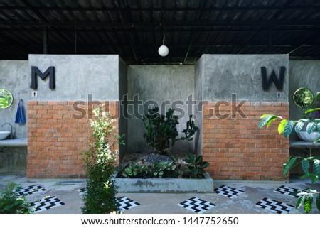 Exterior architecture and decoration of Men and women restroom decorated with brick and cement concrete wall in industrial loft style
