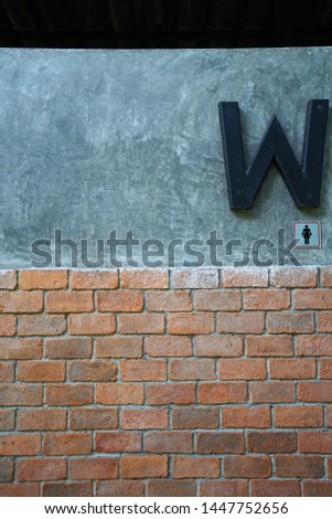 Exterior architecture and decoration of Women restroom decorated with brick and cement concrete wall in industrial loft style