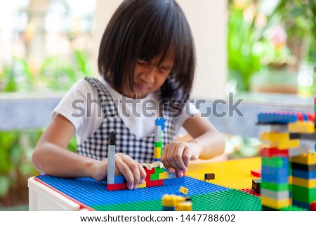 Asian girl kid play lego or toy, Asian girls relax with playing blocks, Asian girls enjoy playing toys.