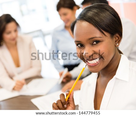 Successful black business woman at the office looking very happy