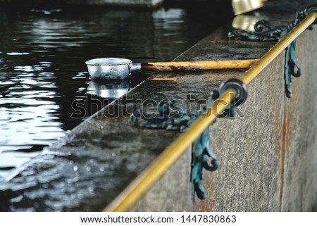 picture showing a water ladle in a ritual well for cleaning at a japanese temple in kyoto