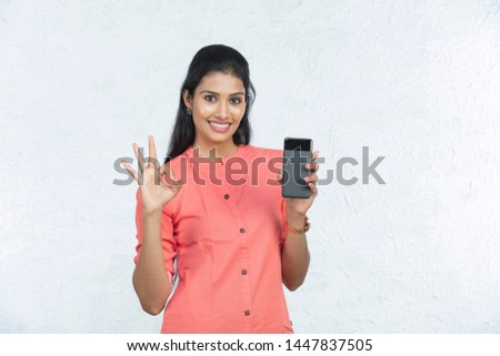 indian beautiful woman holding phone and talking in white background