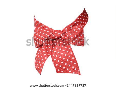 Orange ribbon bow with white dots.