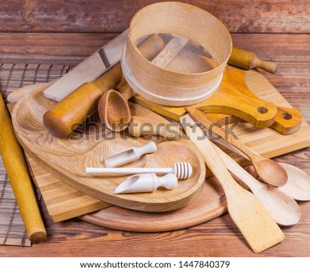 Pile of various kitchen utensils made from different natural wood type on the rustic table
