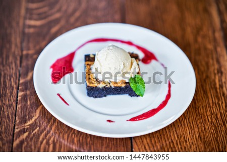 Picture of Brownie Sundae with a Scoop of Vanilla Ice Cream and Berry Sauce