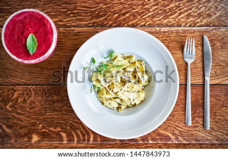 Picture of fresh pasta with creamy sauce on whit plate