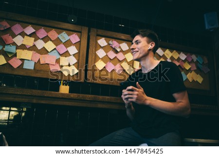 Young man using his smartphone. chatting in social networks with friends. Shopping online.
