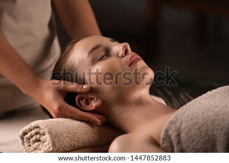 Young woman having massage in spa salon Royalty-Free Stock Photo #1447852883