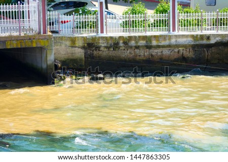 Water pollution. Rusty brown water spills from the treatment plant. Dirty water is mixed with pure blue sea water. Ecological disaster, the threat of pollution. Turkey, Istanbul, Bosphorus.