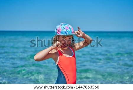 girl in a swimsuit playing on the beach