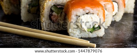 Banner of Set of sushi and maki on black stone table. copy space