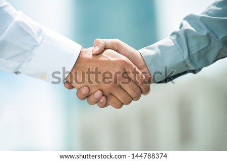 Close-up image of a firm handshake standing for a trusted partnership Royalty-Free Stock Photo #144788374