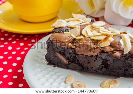 Brownie cake on white dish with almond&chocolate chip