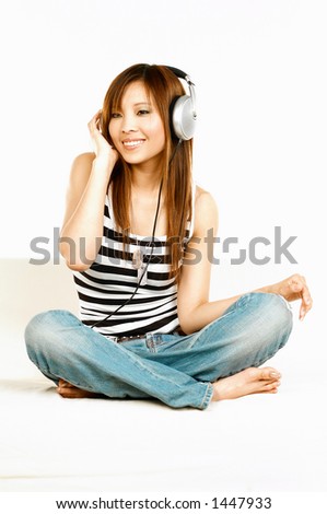 Young asian beautiful women is listening to the music Royalty-Free Stock Photo #1447933