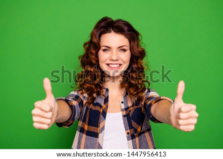 Portrait of her she nice attractive lovely winsome pretty cheerful cheery positive wavy-haired girl wearing checked shirt showing thumbup isolated over bright vivid shine green background