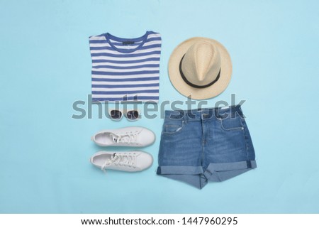 striped dress with jeans shorts and white shoes, hat, on blue background


