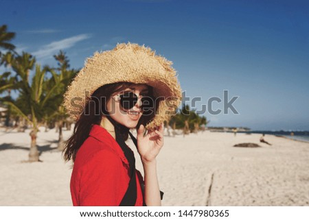    woman in a hat with glasses on the beach                            