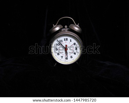 Old clock, alarm clock on black background