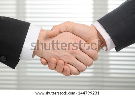 Businessmen shaking hands, isolated on background