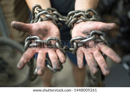 the man's hand chained metal