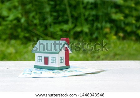 The house is on the twenty euro bills. Conceptual photo. Real estate, investment, mortgage. Green background