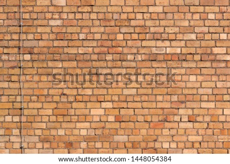 Yellow brick wall with electric cable. Background, texture.