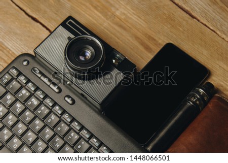 workplace blogger. set to prepare for public speaking and writing text: keyboard and phone on a wooden table, top view. freelance job.