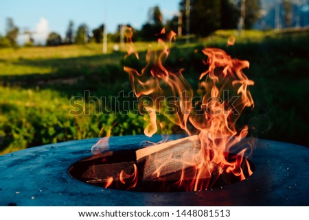 Fire of a barbecue with burning ashes on the air