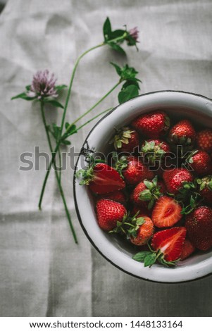 Strawberry in a vintage bowl in the water, still life, close up