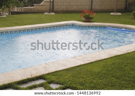 Swimming pool in a private garden in a rainy day