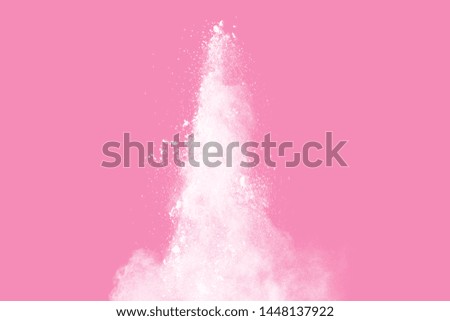 White powder explosion on pink background. White dust splash cloud on pink background.