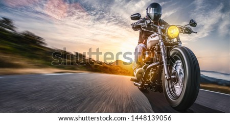 motorbike on the road riding. having fun driving the empty highway on a motorcycle tour journey. copyspace for your individual text. Royalty-Free Stock Photo #1448139056