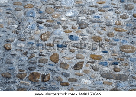 Grey round stoned wall surface as background