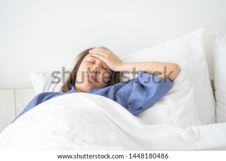 Asian Beautiful Woman Hypothermia has been measured by fever. Lie on the bed to give a body of rehabilitation. The concept of medical care to patients at home by yourself. Royalty-Free Stock Photo #1448180486