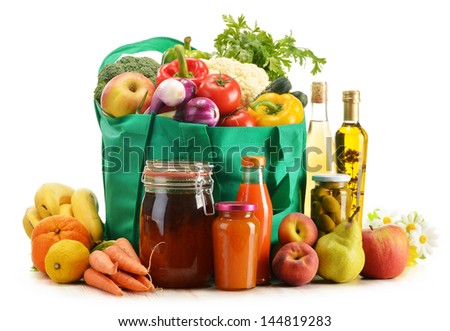 Green shopping bag with grocery products on white background