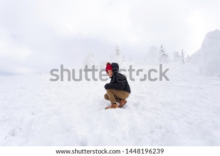Little kid playing in the snow. Travel concept