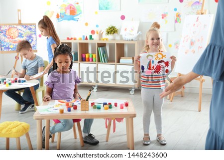 Cute little children at painting lesson indoors