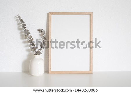 Home decoration with frame poster on table. Scandinavian style Royalty-Free Stock Photo #1448260886