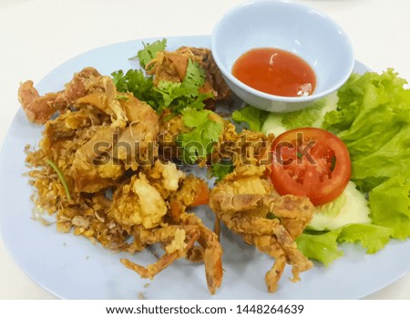Fried soft shell crab with garlic served on a plate at a street restaurant in Bangkok, Thailand Royalty-Free Stock Photo #1448264639
