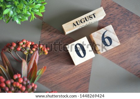 August 6. Date of August month. Diamond wood table for background.
