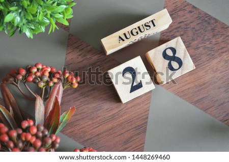 August 28. Date of August month. Diamond wood table for background.