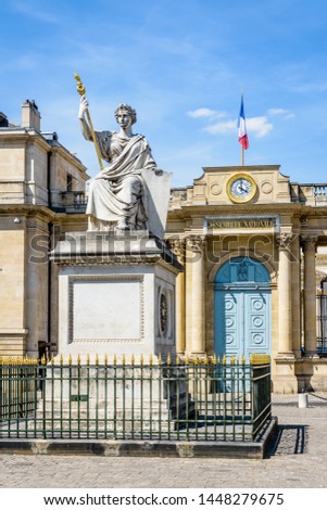 Close-up view of the statue named The Law at the center of the place du Palais Bourbon with the entrance of the Palais Bourbon in the background, seat of the French National Assembly in Paris, France.