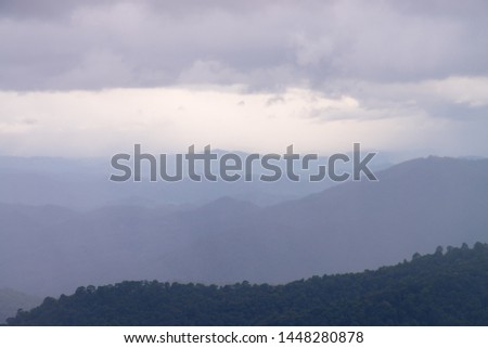 Photograph of beautiful pure nature with golden rain falling on the mountains 