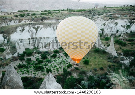 The photo was taken in Turkey, in the name of Cappadocia. The picture shows the flight of balloons over a mountain valley at dawn